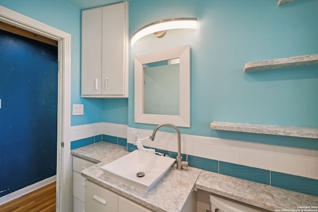 bathroom with hardwood / wood-style floors and sink