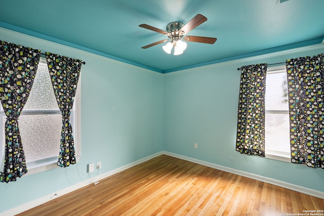 spare room featuring ceiling fan, hardwood / wood-style floors, and crown molding