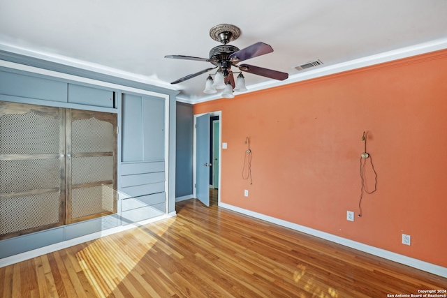 unfurnished bedroom with hardwood / wood-style flooring, ceiling fan, and a closet