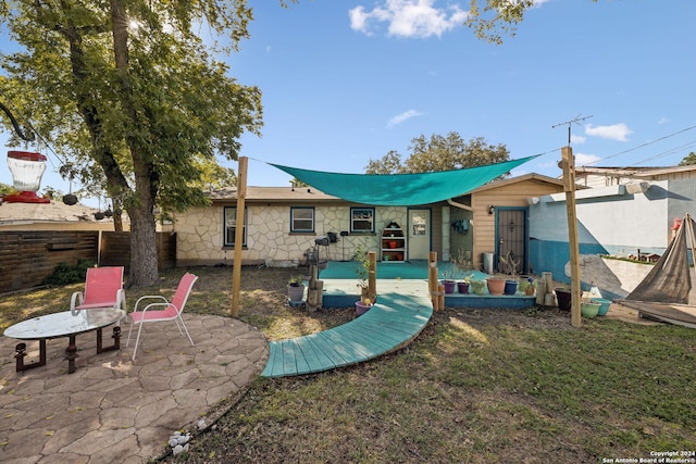 rear view of house featuring a yard and a patio area