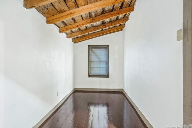 spare room featuring vaulted ceiling with beams, wood-type flooring, and wood ceiling