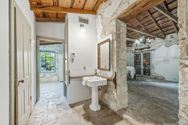 bathroom featuring wooden ceiling, beamed ceiling, a chandelier, and high vaulted ceiling