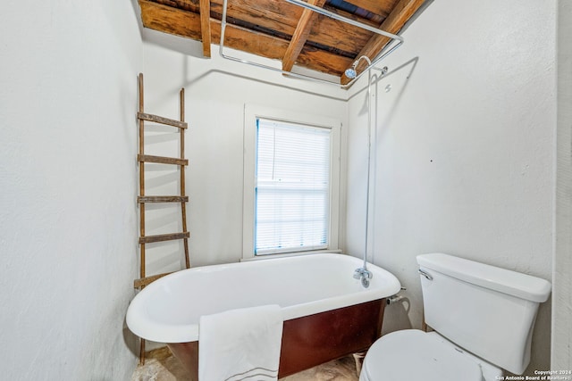 bathroom with a tub to relax in, toilet, and wood ceiling