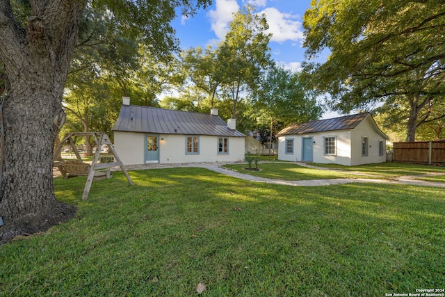 exterior space featuring a lawn and an outbuilding