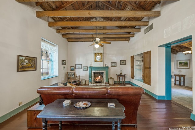 living room featuring beamed ceiling, dark hardwood / wood-style flooring, high vaulted ceiling, and a tiled fireplace