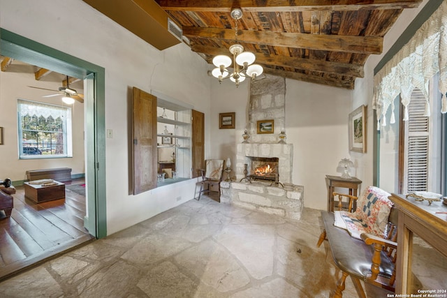 interior space with a stone fireplace, lofted ceiling with beams, wood ceiling, and ceiling fan with notable chandelier