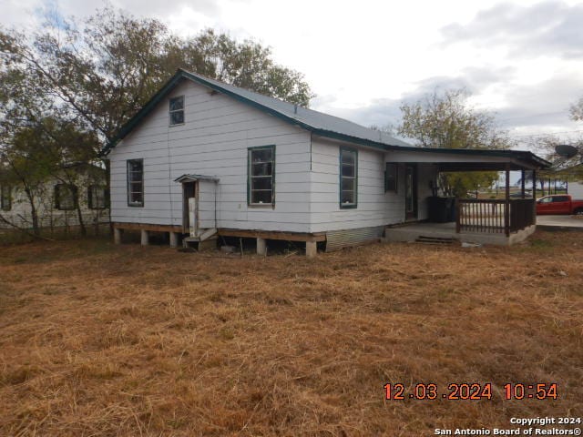 rear view of property featuring a carport