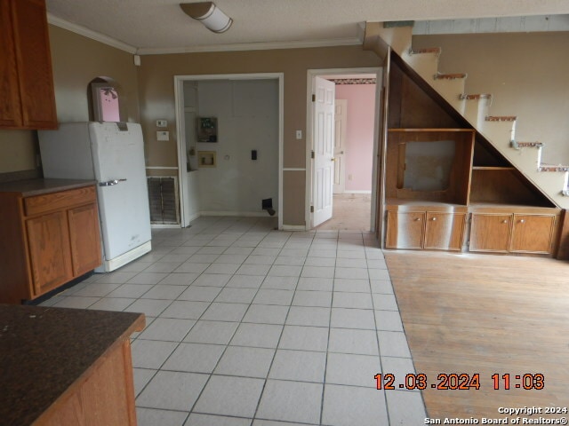 kitchen featuring light tile patterned floors and ornamental molding