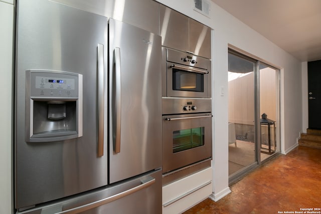 kitchen with stainless steel appliances and concrete floors