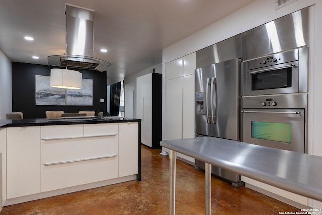 kitchen with white cabinets, island exhaust hood, and appliances with stainless steel finishes