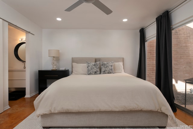 bedroom with hardwood / wood-style flooring, ceiling fan, and ensuite bath