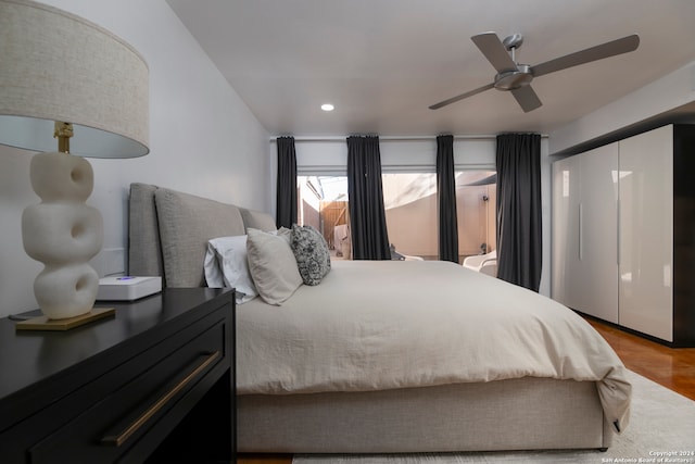 bedroom with ceiling fan and light hardwood / wood-style flooring