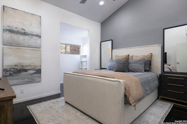 bedroom with dark hardwood / wood-style floors, ceiling fan, and lofted ceiling