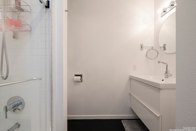 bathroom with vanity and tiled shower