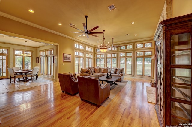 living room featuring crown molding, light hardwood / wood-style flooring, and ceiling fan with notable chandelier