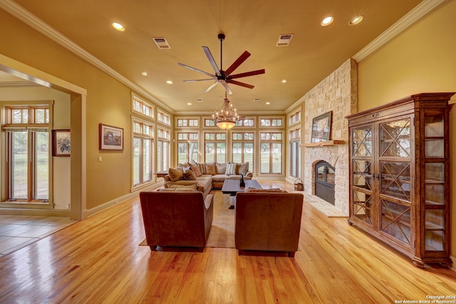 living room featuring a healthy amount of sunlight, ornamental molding, and light wood-type flooring