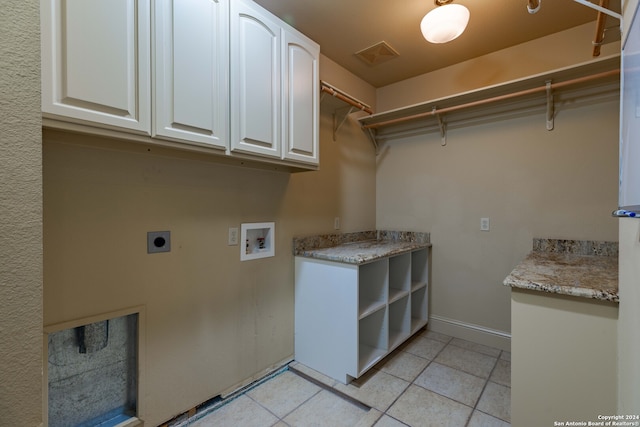 laundry area featuring cabinets, hookup for a washing machine, electric dryer hookup, and light tile patterned flooring