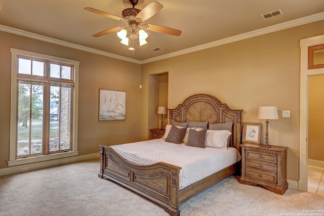 bedroom featuring ceiling fan, crown molding, and light colored carpet