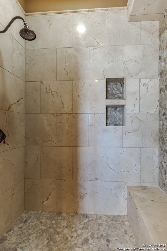 bathroom with a tile shower