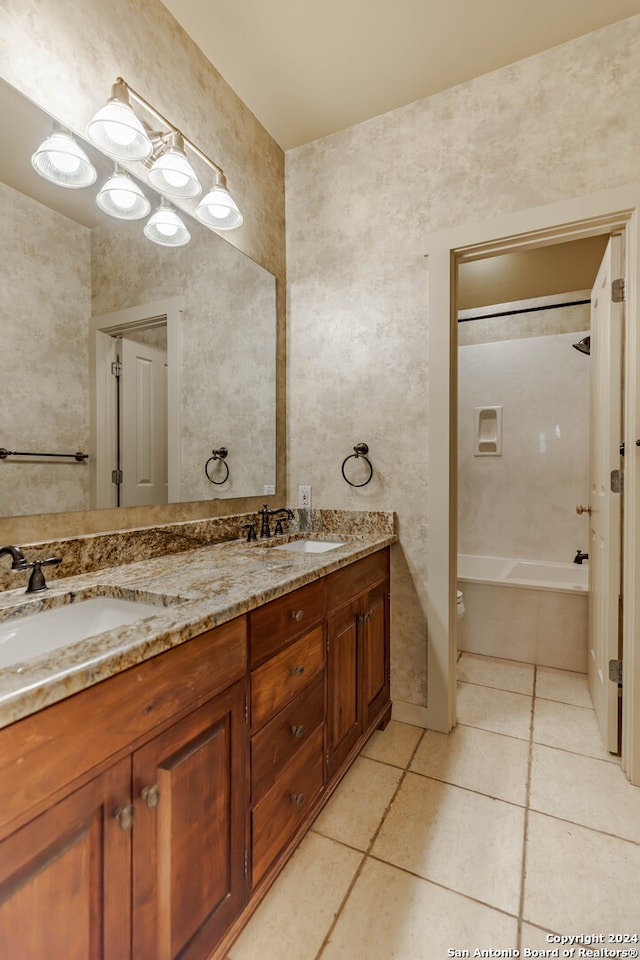 bathroom featuring tile patterned floors, vanity, and tiled shower / bath combo