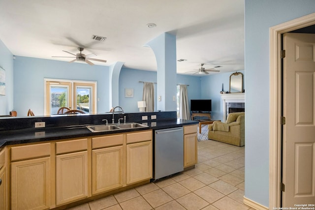 kitchen featuring light brown cabinetry, dishwasher, light tile patterned floors, and sink