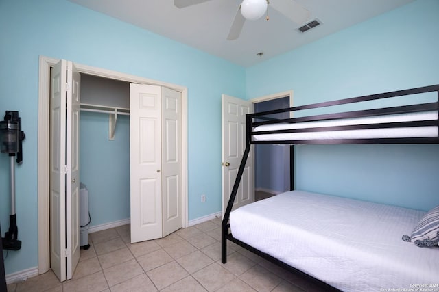 bedroom with light tile patterned floors, a closet, and ceiling fan