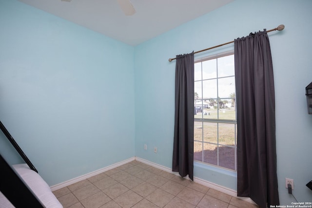 empty room featuring plenty of natural light and light tile patterned floors