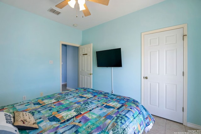 tiled bedroom with ceiling fan