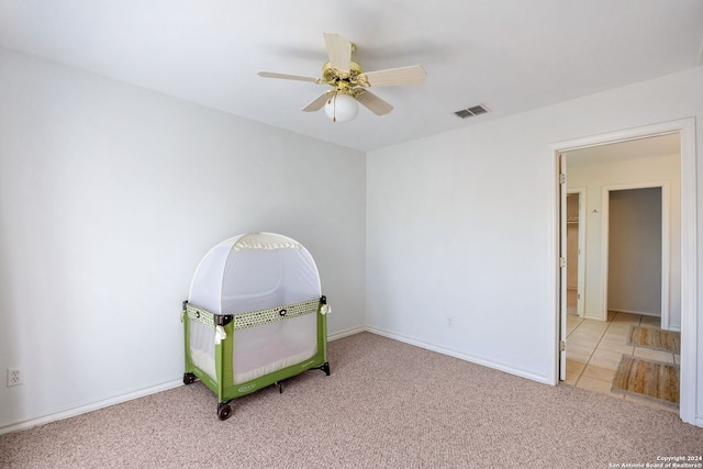 recreation room featuring light carpet and ceiling fan