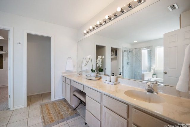 bathroom featuring tile patterned flooring, vanity, and plus walk in shower