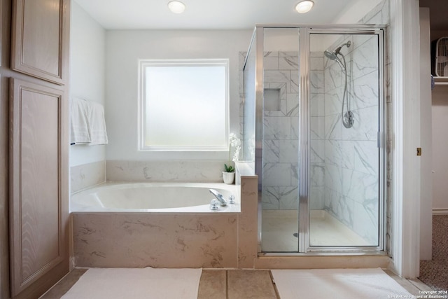 bathroom featuring tile patterned flooring and shower with separate bathtub