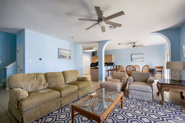 living room featuring light tile patterned floors and ceiling fan