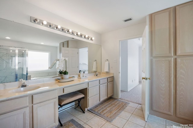 bathroom featuring tile patterned flooring, vanity, and walk in shower