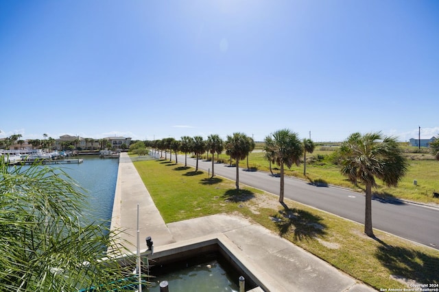 dock area featuring a lawn and a water view