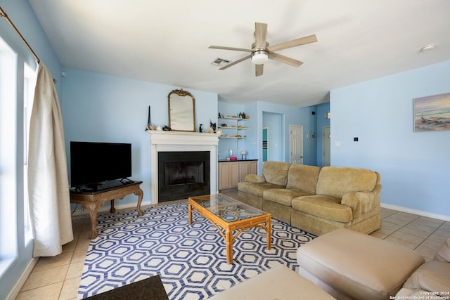 living room featuring ceiling fan, a healthy amount of sunlight, and light tile patterned floors