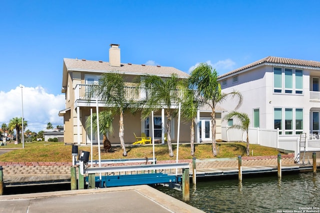 rear view of property featuring a water view