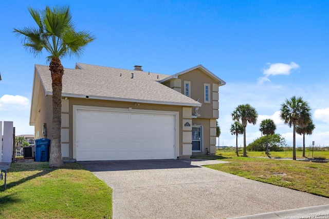 view of front of property featuring a front yard and a garage