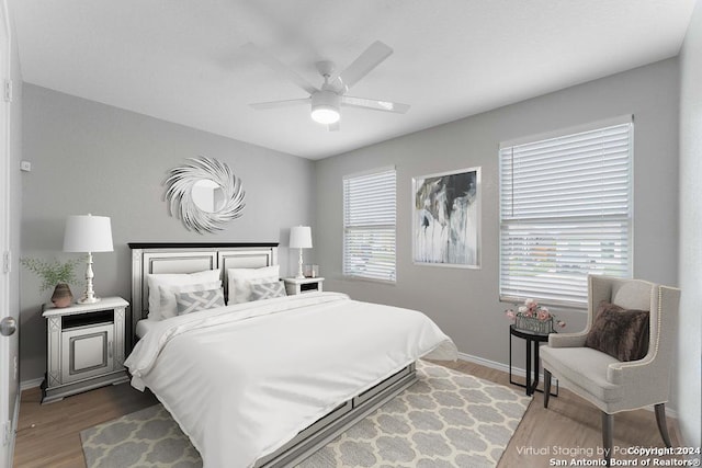 bedroom featuring multiple windows, ceiling fan, and wood-type flooring