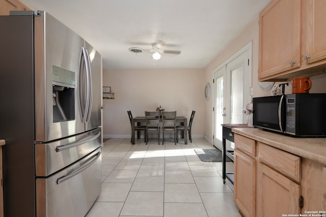 kitchen featuring stainless steel refrigerator with ice dispenser, light brown cabinets, ceiling fan, and light tile patterned flooring