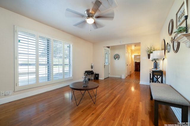 sitting room with ceiling fan and hardwood / wood-style flooring