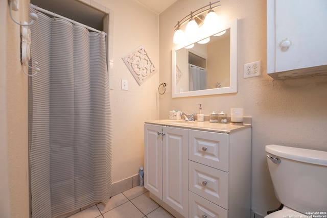 bathroom featuring tile patterned flooring, vanity, and toilet