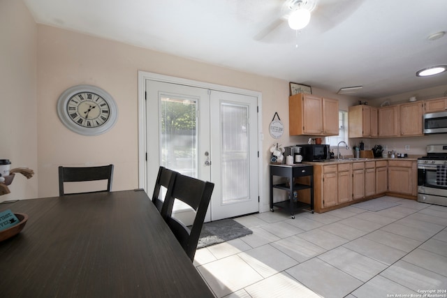 kitchen featuring ceiling fan, sink, french doors, light tile patterned floors, and appliances with stainless steel finishes