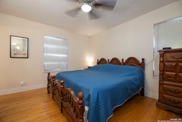 bedroom with light hardwood / wood-style floors and ceiling fan