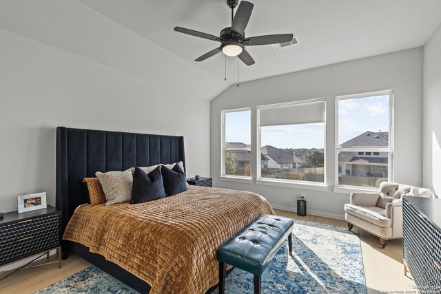 bedroom with wood-type flooring, ceiling fan, and lofted ceiling