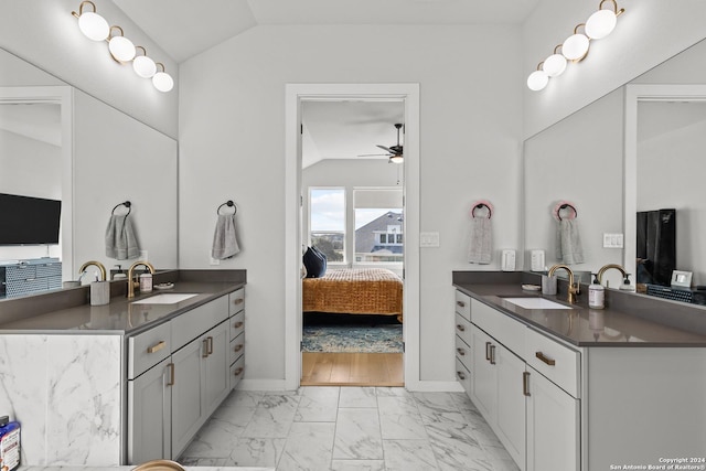 1521 Escarpment, New Braunfels, TX 78132 - full bath with lofted ceiling, ensuite bath, marble look tiles, two vanities, and a ceiling fan