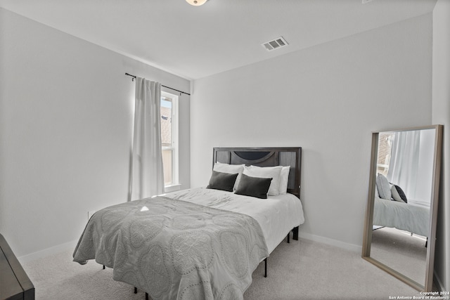 bedroom with light colored carpet