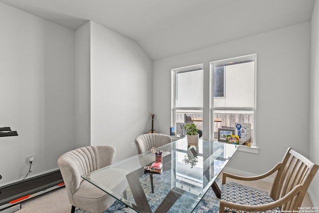 dining room with carpet flooring and lofted ceiling