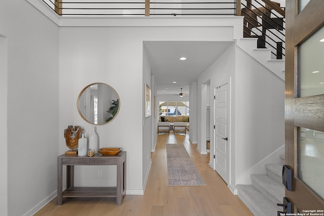 1521 Escarpment, New Braunfels, TX 78132 - hallway with stairway, light wood-style flooring, baseboards, and recessed lighting