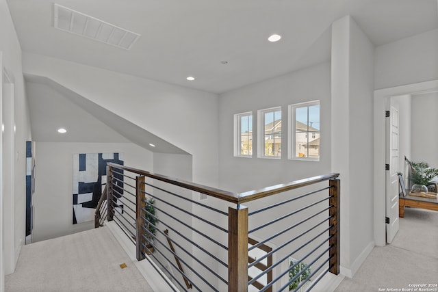 hallway with light colored carpet