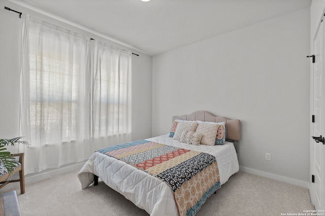 bedroom with light colored carpet